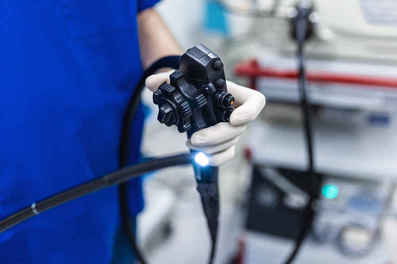 Doctor holding a colonoscope before a colonoscopy procedure