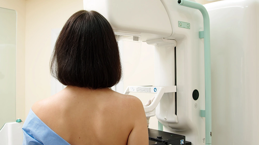 A patient undergoing a mammogram screening